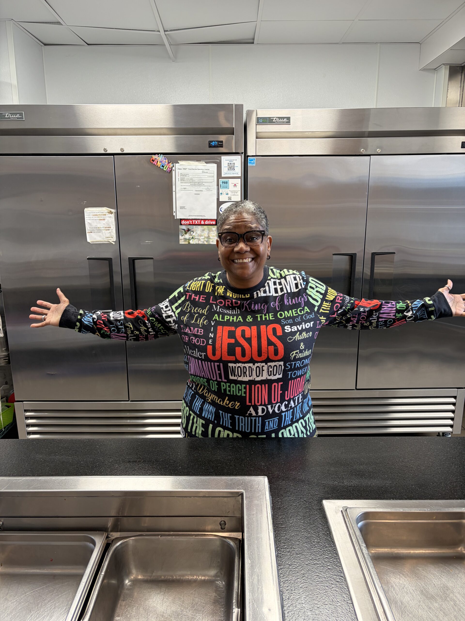 Lucretia Bowman shows off the kitchen Impact 100 helped fund at the Martha S. Lindner Center for Transformation