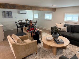 Lucretia sits in a comfortable gathering space for residents of City Gospel Mission’s newest apartment building.