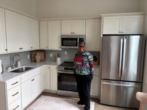 Lucretia Bowman proudly stands in a new kitchen in City Gospel Mission’s affordable, newly renovated apartment building on Goethe Street.